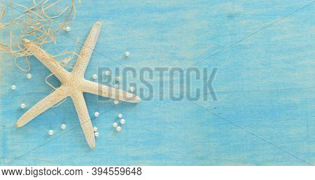 Seastar With Pearls On Shabbed Blue Colored Desk