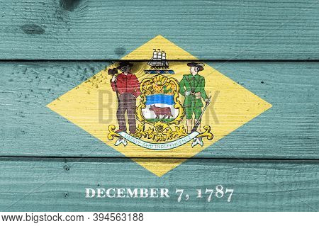 Delawere Flag Painted On Old Wood Plank Background. Brushed Natural Light Knotted Wooden Board Textu