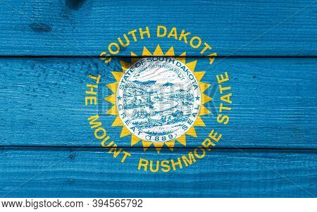 South Dakota Flag Painted On Old Wood Plank Background. Brushed Natural Light Knotted Wooden Board T