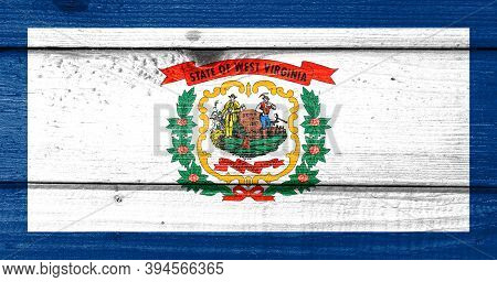 West Virginia Flag Painted On Old Wood Plank Background. Brushed Natural Light Knotted Wooden Board 