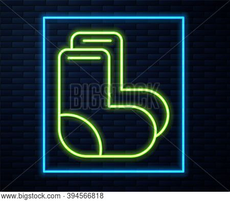 Glowing Neon Line Valenki Icon Isolated On Brick Wall Background. National Russian Winter Footwear. 