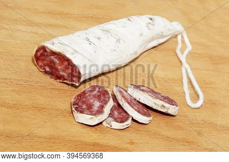 Close-up Italian And Catalonia Fuet Cured Pork Sausage With Slices On Wooden Table. Sausage From Min