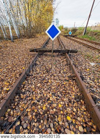 Wooden Buffer Stop With Blue Sign Stop. The Sign Ending Rail Tracks Concept For Limit, Limitation Re