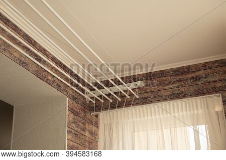 A Ceiling Linen Drayer Hanger In The Interior Of The Modern Room