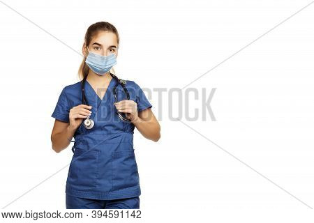 Young Beautiful Woman Doctor In Blue Surgical Gown With Stethoscope Isolated On White Background. Co