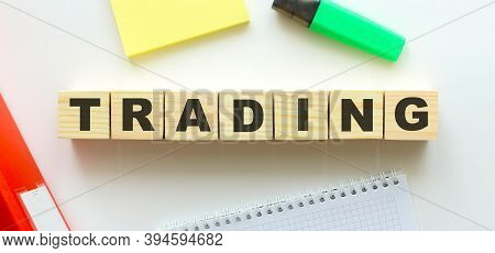 Wooden Cubes With Word Traiding On The Office Desk.