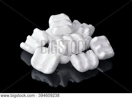 Group of m-shaped styrofoam packing chips isolated on black