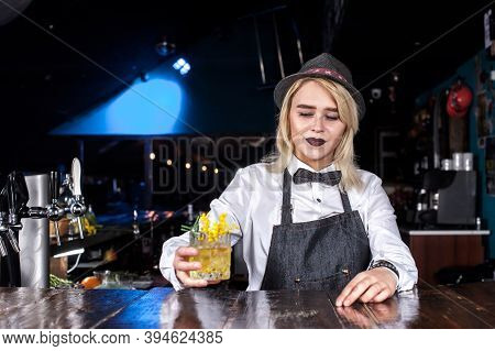 Focused Girl Bartending Creates A Cocktail At Bar