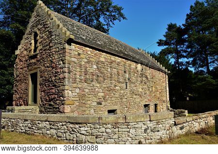 An Exterior View Of The Old Stone Church Building And Tithe Barn In The Borders Village Of Foulden I