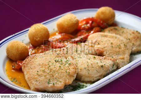 San Jacobos, Pork Loin Stuffed With Ham And Cheese. Accompanied By Red Peppers