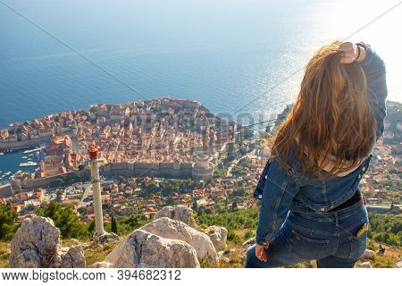 Over The Shoulder View Of A Girl Standing On Top Of The Srd Mountain, Looking Down On Dubrovnik City