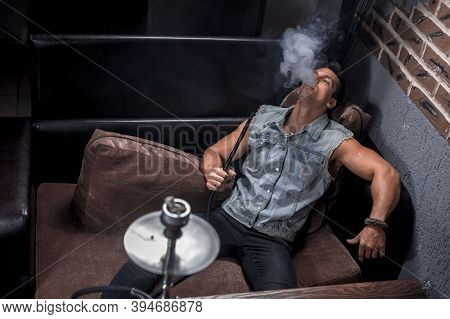 Brutal Guy Smoking Hookah In The Shisha Hose.
