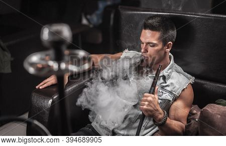 Brutal Man In The Hookah Room In Night Club.