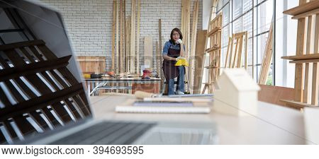 Beautiful Asian Adult Woman Wearing Jeans Clothes Working As A Carpenter In Room At Home. Concept Fo