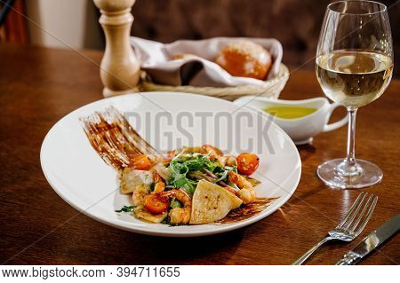 Fresh Salad Plate With Shrimp, Tomato And Mixed Greens On Wooden Background Close Up. Healthy Food.