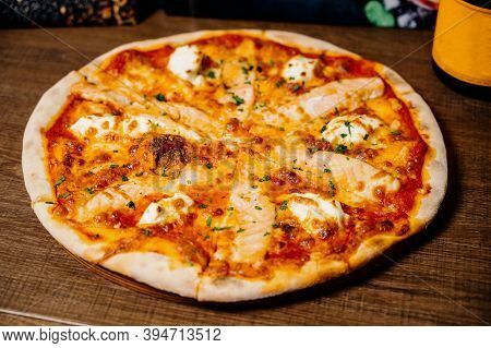 Pizza With Chicken, Mozzarella, Olives And Basil Top View With Copy Space