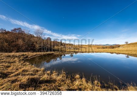 Small Lake For Cows In Lessinia Plateau Regional Natural Park, Corno D'aquilio. In The Background Th