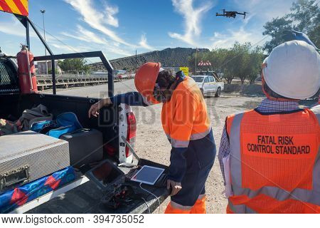 a team of workers in a diamond mine in Botswana operating a drone