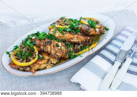 Chicken Francese, Italian-american Dish - Fried Chicken Breast In A Sauce Of Lemon Slices On A White