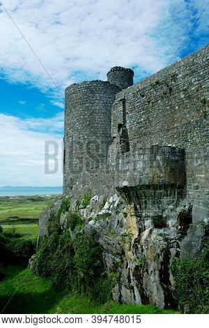 Harlech Castle, Wales. Dramatic, Imposing, Defensive Walls. Vertical Shot With Blue Sky Background F