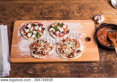 Cooking Traditional Italian Mini Pizza, Pizzetta - Mini Pizza With Tomato Sauce, Salami, Jamon And M
