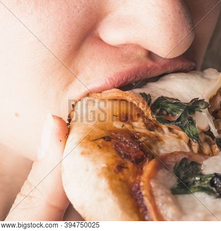 Traditional Italian Appetizer - Woman Eats Mini Pizza, Pizzetta With Sausage, Olives And Mozzarella 