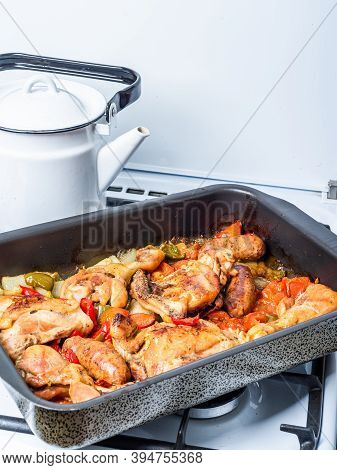 Home Cooked Chicken Scarpariello In A Baking Sheet On A Gas Stove - Chicken With Sausages And Vegeta