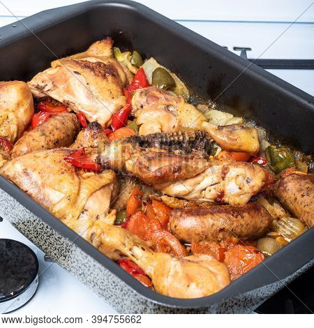 Chicken Scarpariello Close-up In A Baking Sheet - Chicken With Sausages, Peppers, Onions And Pomiodo