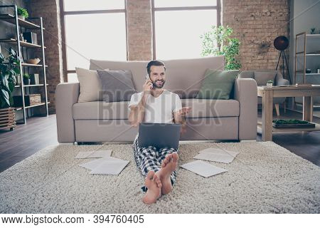 Photo Of Positive Man Manager Marketer Sit Floor Carpet Work Remote Laptop Call Smartphone Colleague