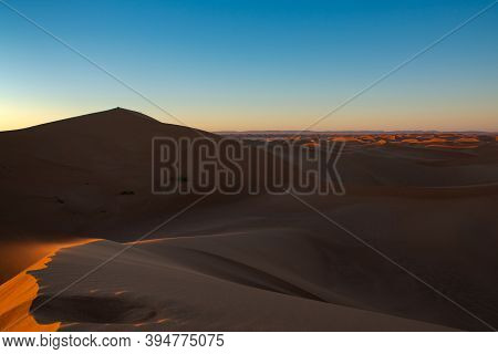 Huge Desert Dunes Of Erg Chigaga, At The Gates Of The Sahara, Al Amanecer. Morocco. Concept Of Trave