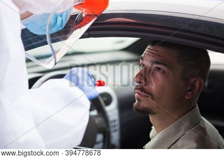 Young Male In Covid-19 Drive Thru Mobile Testing Center Having Nasal Swab Taken,coronavirus Testing 