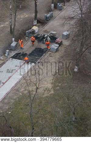 The Masters Lays Paving Stones. Sidewalk Repair. Road Workers Aerial View. Filling The Base Of The S