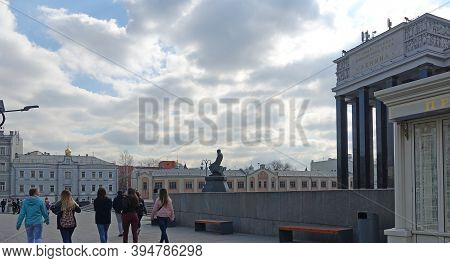 Moscow, Russia. April 7 2019 Monument To F.m. Dostoevsky And The Building Of The Lenin Russian State