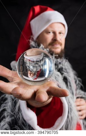 Cheerful Santa Dressed In Fur Skin With Crystal Spehre