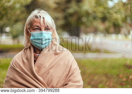 Woman Wearing Protective Face Mask And In A Warm Cashmere Scarf In Park Outdoor During Quarantine Of