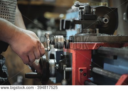 Worker Is Working On The Lathe Machine Close Up.
