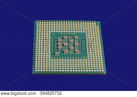 Photo Of A Cpu Chip Isolated On A Blue Background . Microprocessor, Central Processing Unit. Compute
