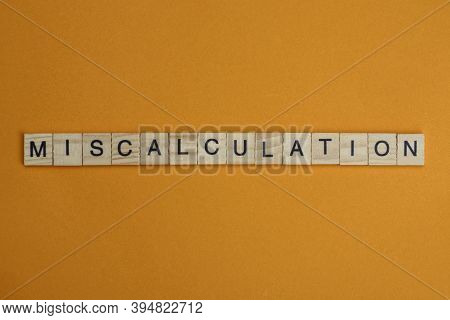 Gray Word Miscalculation Made Of Wooden Square Letters On Brown Background
