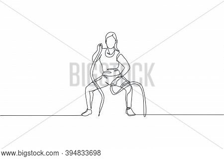Single Continuous Line Drawing Of Young Sportive Woman Training With Battle Rope In Sport Gymnasium 