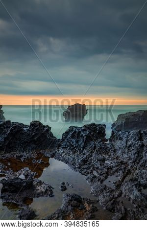Picturesque Seascape. Amazing Landscape. Rock In The Ocean. Motion Waves. Silky Water. Long Exposure