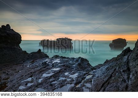 Picturesque Seascape. Amazing Landscape. Rock In The Ocean. Motion Waves. Silky Water. Long Exposure
