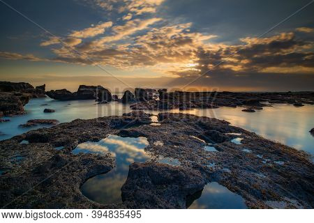 Beautiful Seascape. Long Exposure Rocky Beach During Low Tide. Panoramic Ocean View. Composition Of 