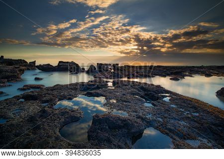 Beautiful Seascape. Long Exposure Rocky Beach During Low Tide. Panoramic Ocean View. Composition Of 
