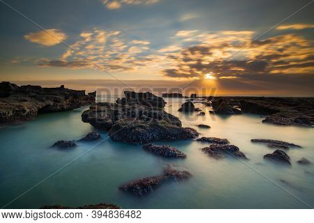 Beautiful Seascape. Long Exposure Rocky Beach During Low Tide. Panoramic Ocean View. Composition Of 