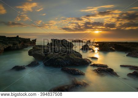Beautiful Seascape. Long Exposure Rocky Beach During Low Tide. Panoramic Ocean View. Composition Of 