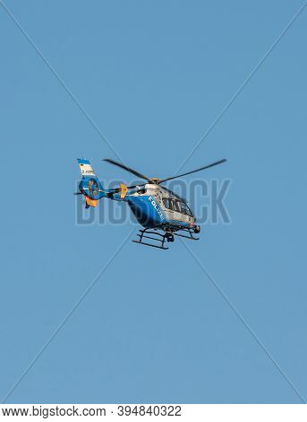Germany Koblenz 05.04.2020 D-hrpb Police Helicopter Flies Over The City In Blue Sky Background Searc