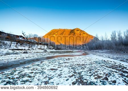 Beautiful Sunny Winter Landscape With Ice River And The Mountain.