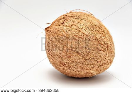 Healthy Food - Whole Coconut In Close-up With Copy Space. Isolated On White Background.