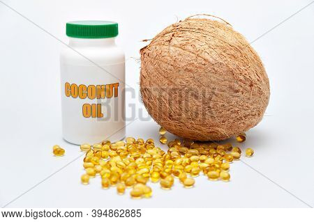Health Care - Nutritional Supplement And Healthy Food - Bottle Of Coconut Oil With Whole Coconut On 