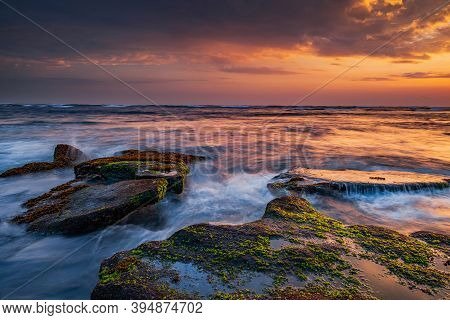 Beautiful Seascape. Beach With Stones Covered By Seaweeds. Low Tide. Composition Of Nature. Motion W